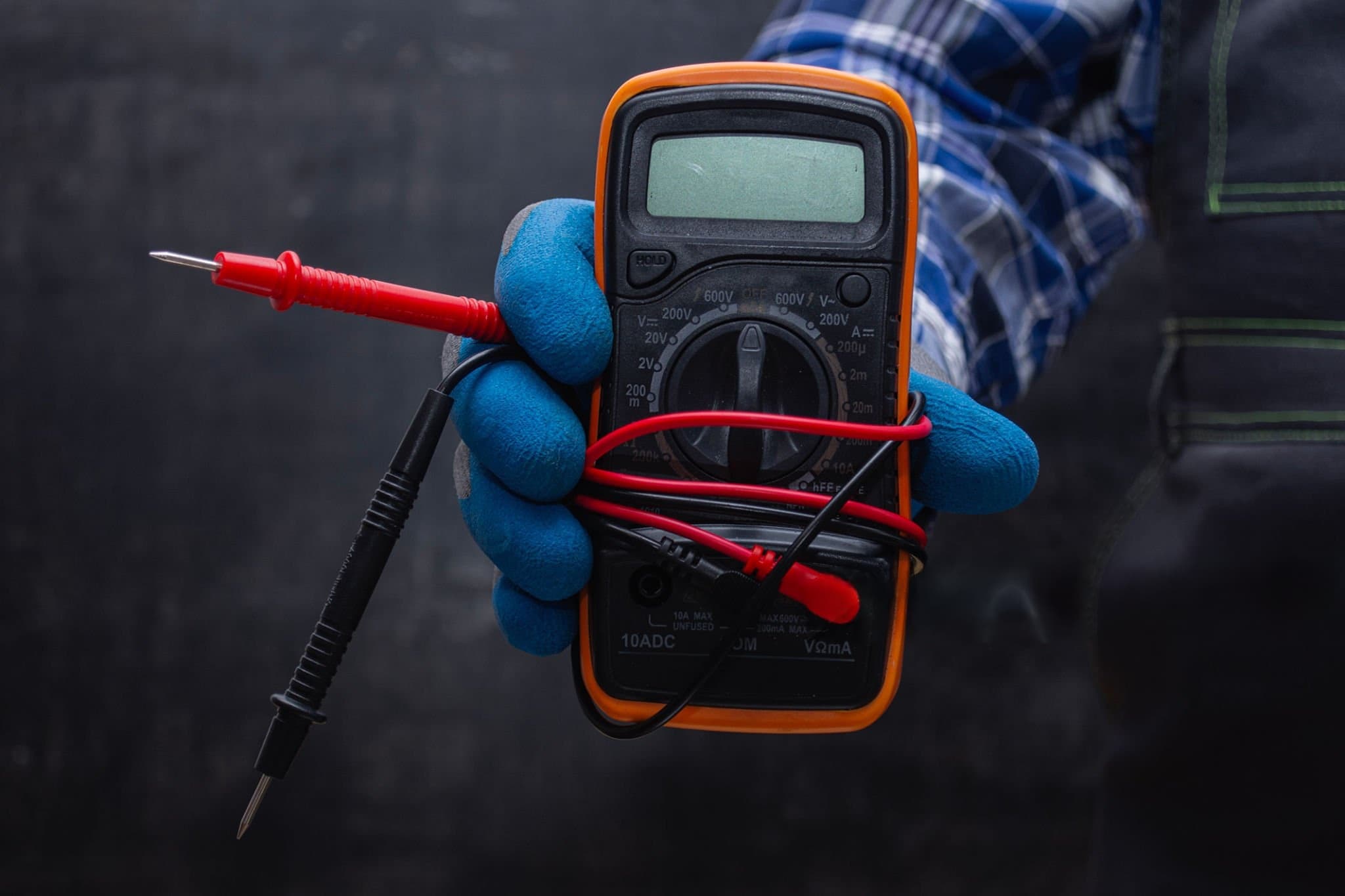 Professional electrician installing ceiling light fixture