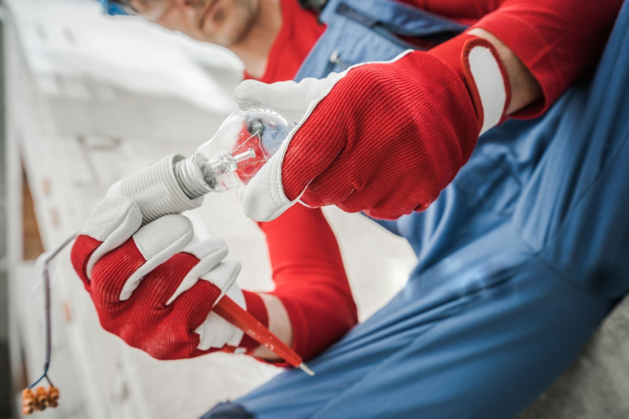 An electrician repairing a fuse box